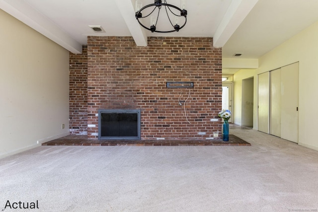 unfurnished living room featuring carpet floors, a brick fireplace, beam ceiling, and visible vents