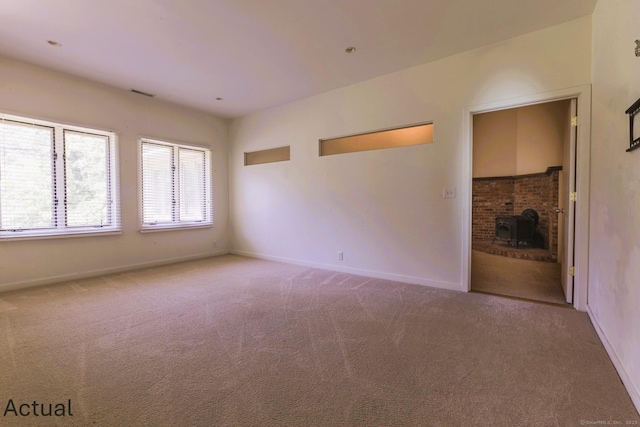 unfurnished living room featuring baseboards, carpet, and visible vents