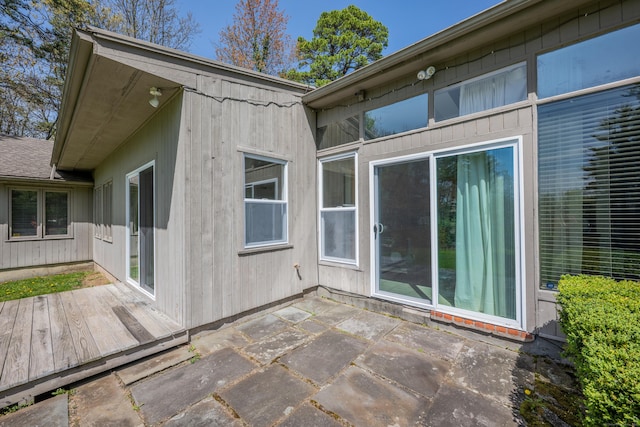 back of property featuring a patio and a deck