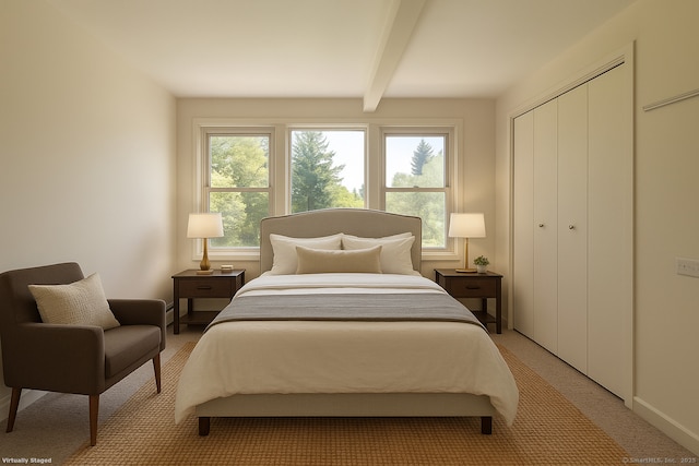 bedroom with a closet, baseboards, beam ceiling, and light colored carpet