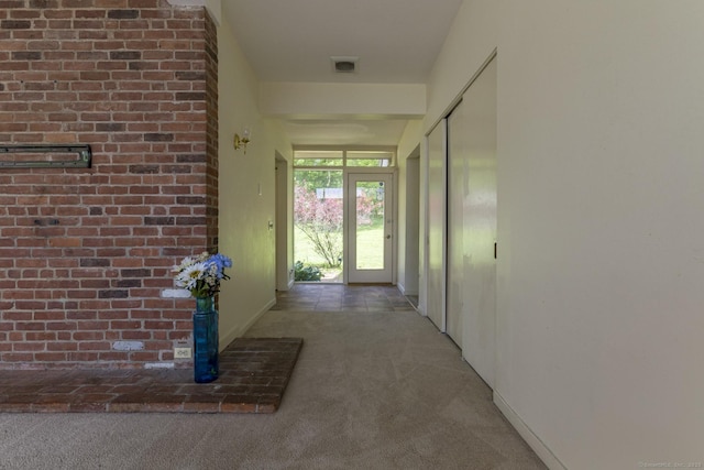 corridor with carpet flooring, baseboards, and visible vents