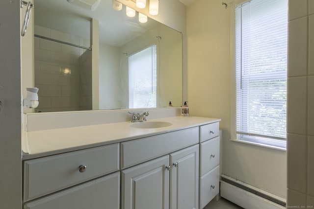 bathroom featuring vanity, plenty of natural light, and a baseboard heating unit