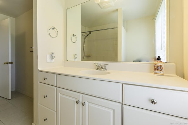 full bath featuring a shower, tile patterned flooring, and vanity