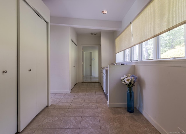 hall featuring recessed lighting, baseboards, visible vents, and light tile patterned floors
