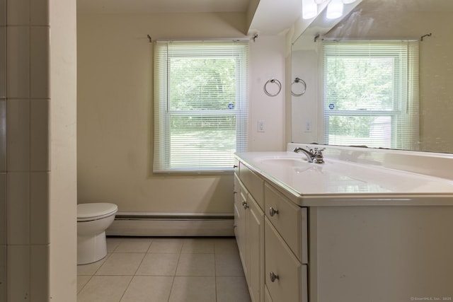 bathroom with baseboard heating, tile patterned flooring, vanity, toilet, and a wealth of natural light
