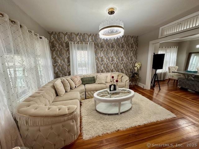 living area with an inviting chandelier and wood finished floors