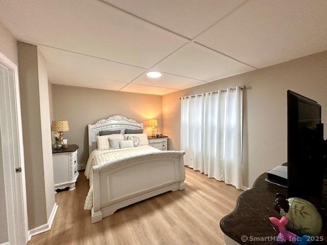 bedroom with light wood-style floors and recessed lighting