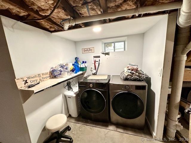 clothes washing area with washer and dryer and laundry area