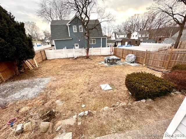 view of yard featuring a residential view and a fenced backyard