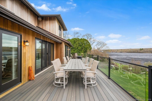 wooden deck featuring outdoor dining space and a water view