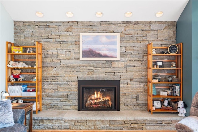 living area featuring a fireplace and recessed lighting