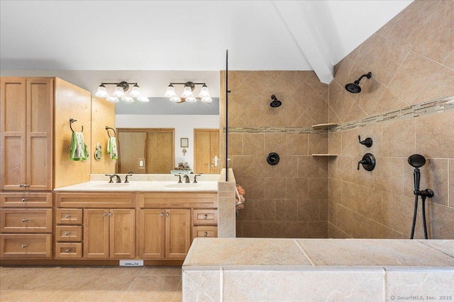 bathroom with double vanity, walk in shower, a sink, and tile patterned flooring