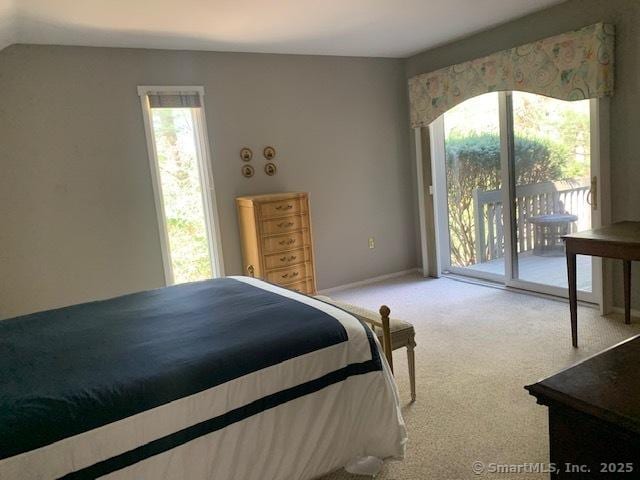 bedroom with access to outside, baseboards, multiple windows, and carpet