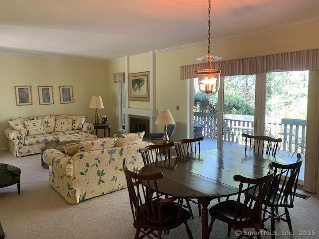 dining room with carpet floors and ornamental molding