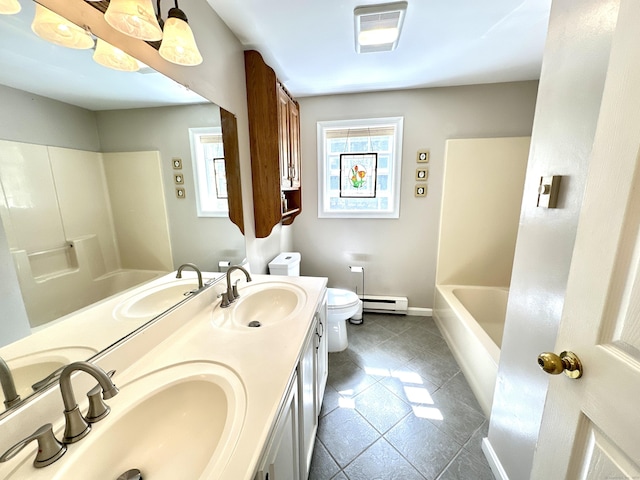 bathroom featuring visible vents, a sink, a baseboard heating unit, and tile patterned floors