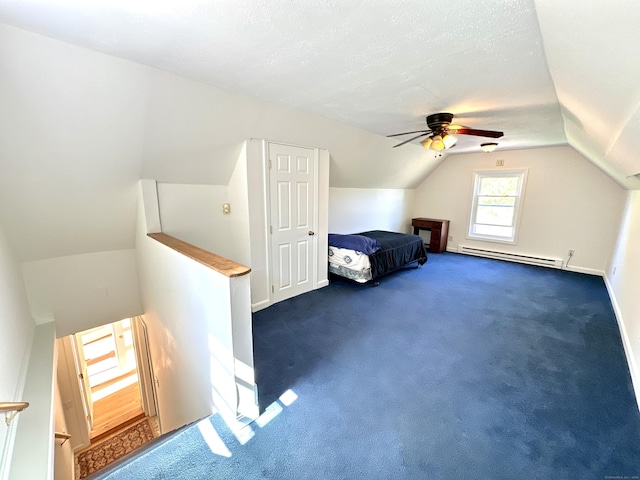 bonus room featuring dark carpet, a ceiling fan, baseboards, lofted ceiling, and a baseboard radiator