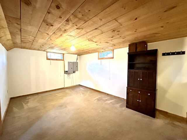 below grade area with baseboards, electric panel, and wooden ceiling