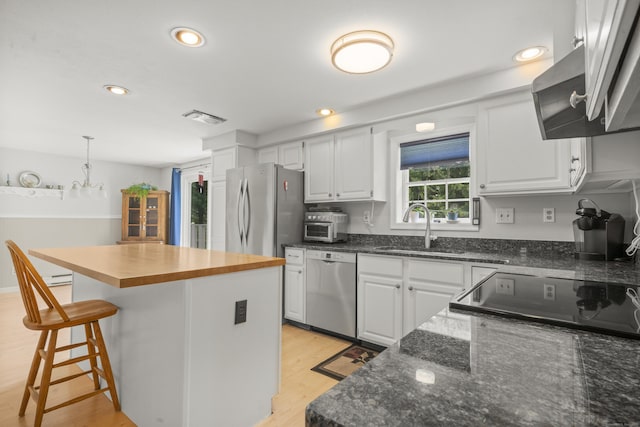 3 Eastwood Dr, Granby, CT 06060 - kitchen featuring a sink, appliances with stainless steel finishes, a breakfast bar area, white cabinetry, and recessed lighting