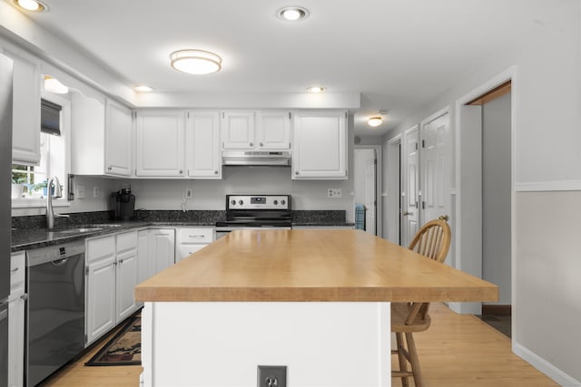 3 Eastwood Dr, Granby, CT 06060 - kitchen with stainless steel range with electric stovetop, dishwashing machine, under cabinet range hood, a sink, and light wood-style flooring