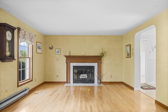 3 Eastwood Dr, Granby, CT 06060 - unfurnished living room featuring a baseboard radiator, hardwood / wood-style flooring, a premium fireplace, and baseboards