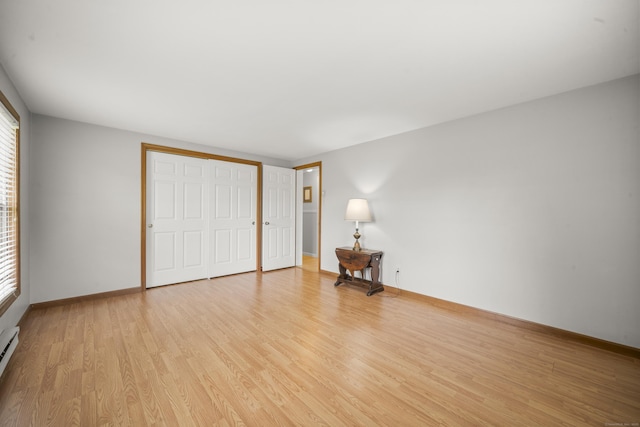 3 Eastwood Dr, Granby, CT 06060 - unfurnished bedroom with wood finished floors, baseboards, a baseboard radiator, and a closet
