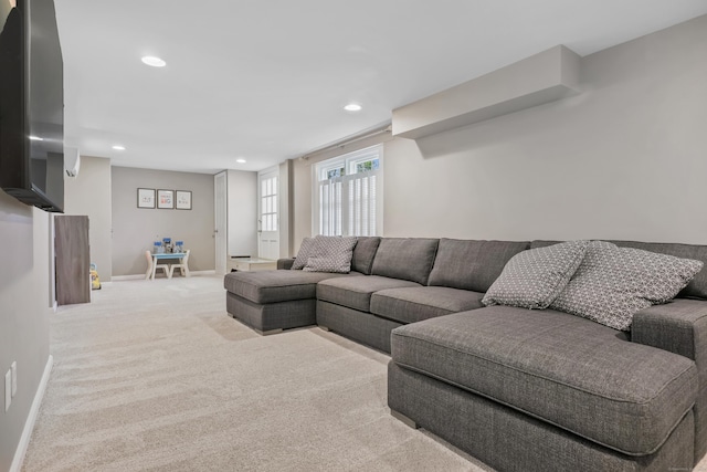 living room with recessed lighting, baseboards, and carpet
