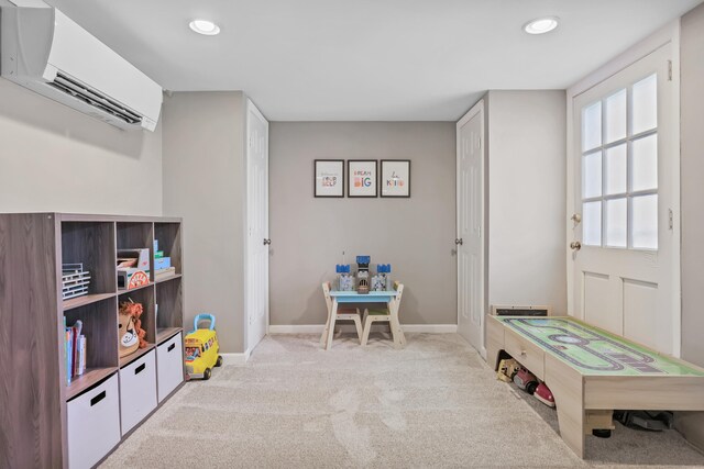 recreation room featuring baseboards, carpet flooring, recessed lighting, and a wall mounted air conditioner
