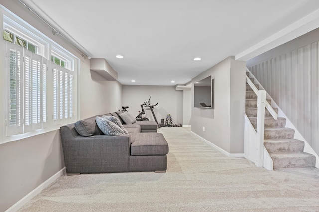 carpeted living area with baseboards, recessed lighting, and stairs