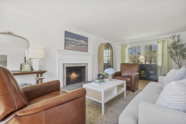 living room with plenty of natural light and a brick fireplace