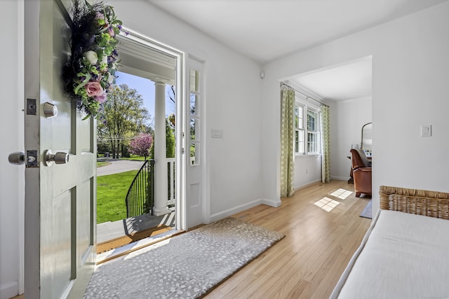 entryway with baseboards and wood finished floors