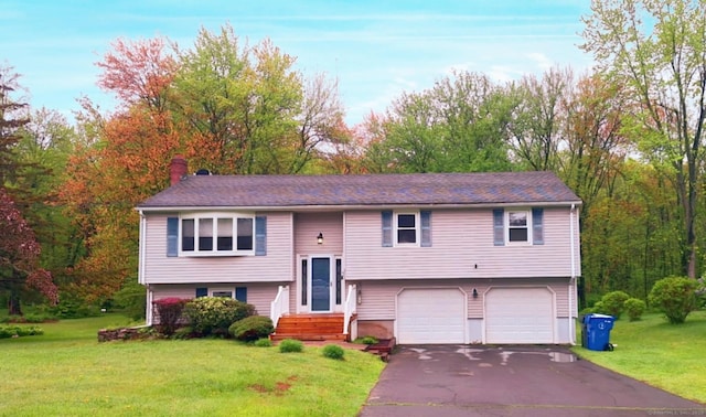 283 Hillcrest Ave, Newington, CT 06111 - raised ranch featuring a garage, asphalt driveway, a chimney, and a front lawn