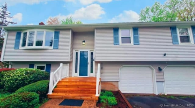 283 Hillcrest Ave, Newington, CT 06111 - split foyer home with an attached garage and asphalt driveway