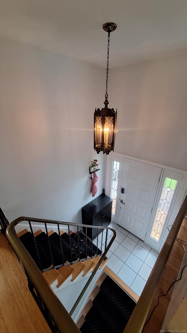 283 Hillcrest Ave, Newington, CT 06111 - entryway with a chandelier, tile patterned floors, stairway, and a high ceiling