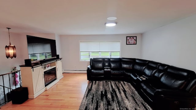 283 Hillcrest Ave, Newington, CT 06111 - living room with baseboard heating, light wood finished floors, and a glass covered fireplace