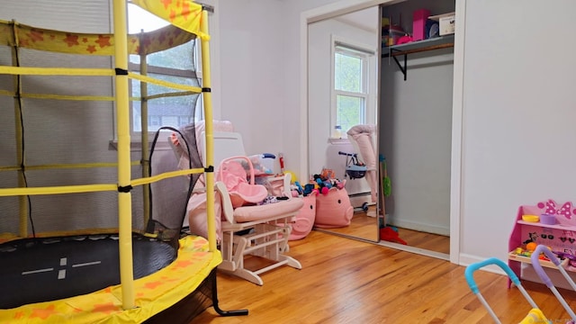 283 Hillcrest Ave, Newington, CT 06111 - bedroom with wood finished floors, a baseboard heating unit, and a closet