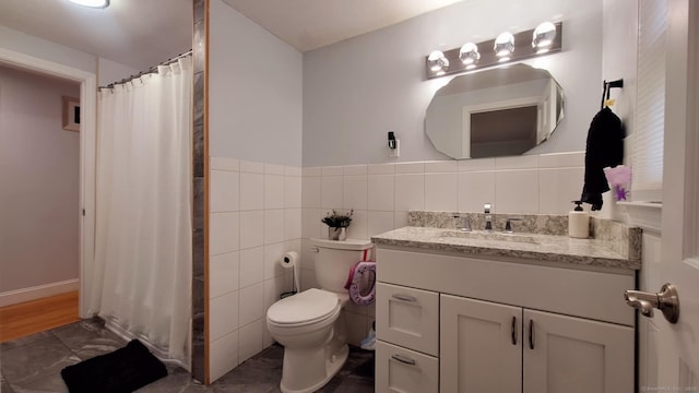 283 Hillcrest Ave, Newington, CT 06111 - full bath with toilet, vanity, tile walls, a shower with curtain, and wainscoting