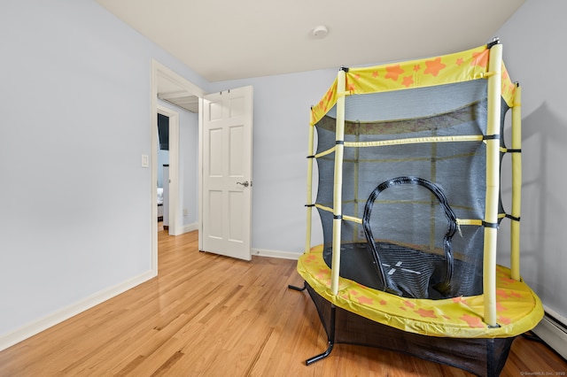 283 Hillcrest Ave, Newington, CT 06111 - bedroom with wood finished floors, baseboards, and a baseboard radiator