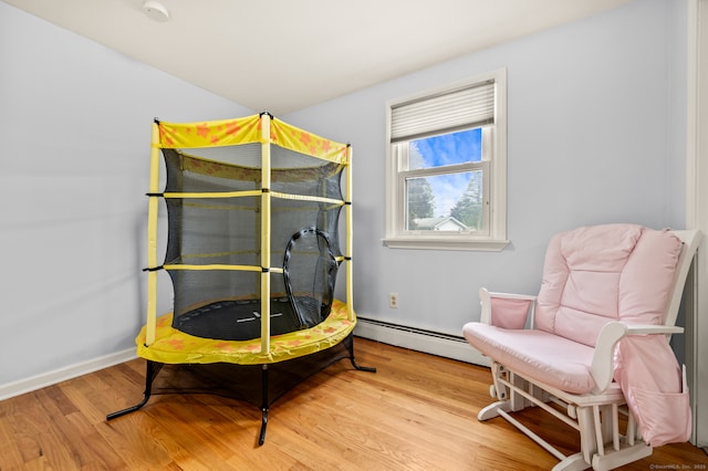 283 Hillcrest Ave, Newington, CT 06111 - bedroom with a baseboard heating unit and wood finished floors