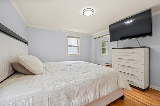 283 Hillcrest Ave, Newington, CT 06111 - bedroom featuring crown molding, a closet, light wood-type flooring, baseboards, and a baseboard heating unit