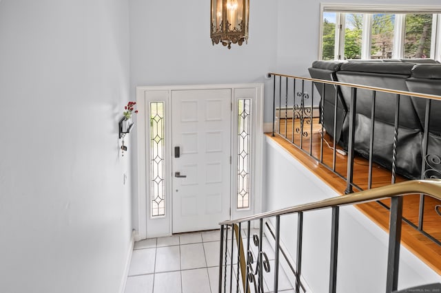 283 Hillcrest Ave, Newington, CT 06111 - entryway featuring tile patterned flooring, baseboards, a baseboard heating unit, and a chandelier