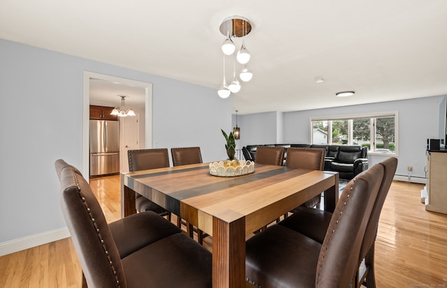 283 Hillcrest Ave, Newington, CT 06111 - dining area with a baseboard heating unit, baseboards, light wood-style flooring, and a chandelier