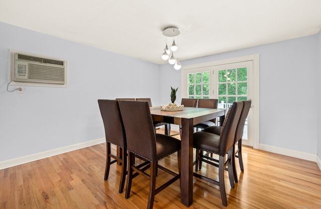 283 Hillcrest Ave, Newington, CT 06111 - dining area featuring an AC wall unit, light wood-style flooring, and baseboards