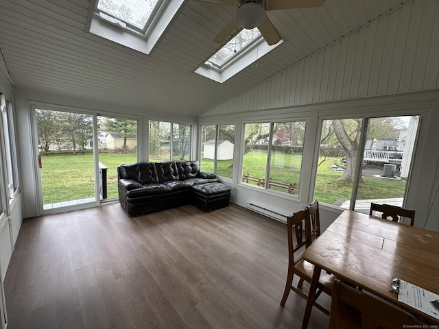 sunroom with a skylight, ceiling fan, and baseboard heating