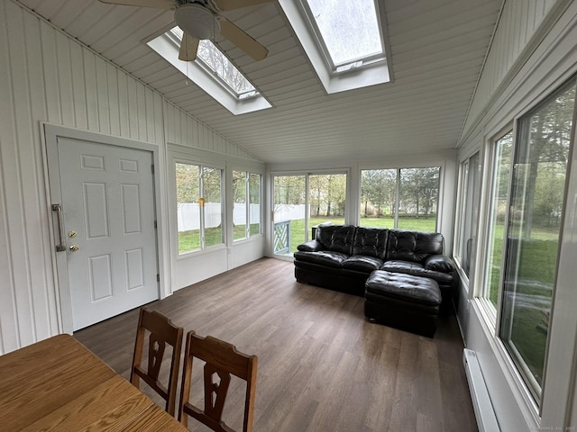 sunroom with plenty of natural light, lofted ceiling with skylight, and wood finished floors