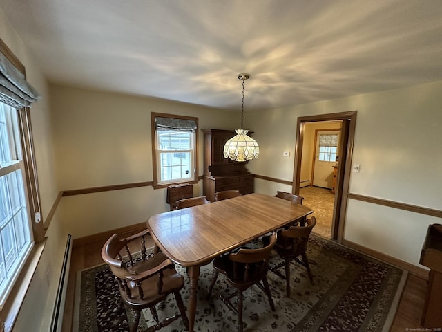 dining area with baseboards, a notable chandelier, and a wealth of natural light