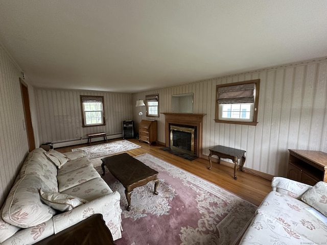 living room with a fireplace, wallpapered walls, and wood finished floors