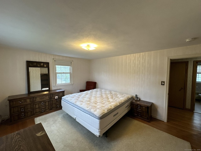 bedroom with baseboards and wood finished floors