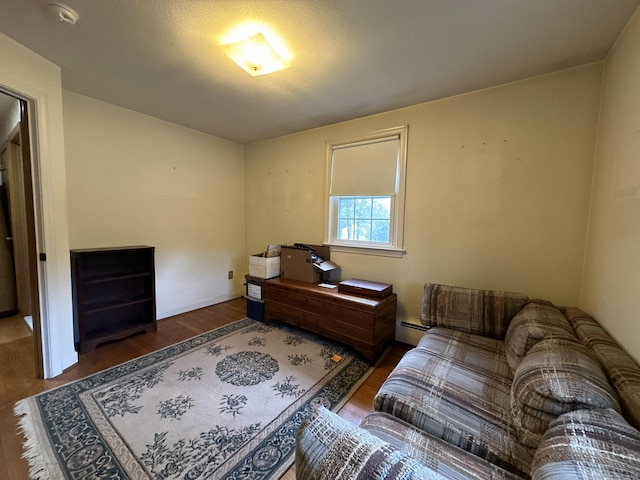 interior space with baseboards, a baseboard radiator, and wood finished floors