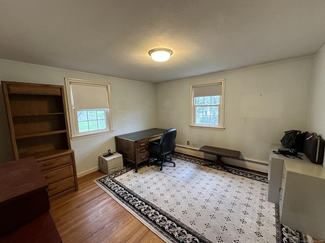 office area featuring baseboards and wood finished floors