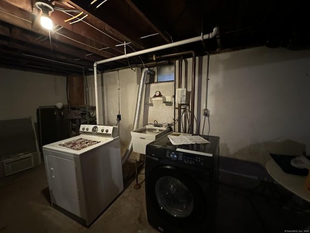 laundry area featuring laundry area, a sink, and washing machine and dryer